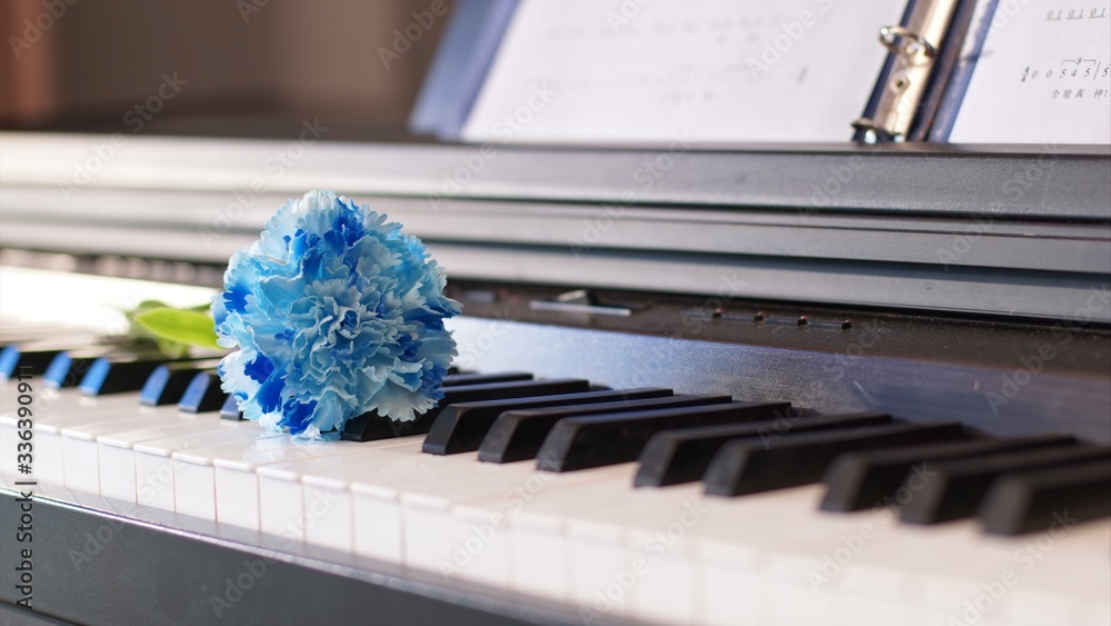 Close-up of modern piano and blue flowers indoors. Concept of stay at home