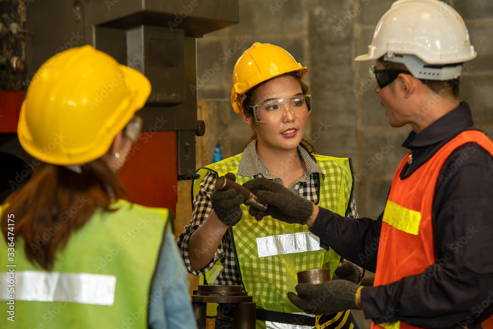 Engineers working in the factory,Team of workers and foreman checking machines in at factory.