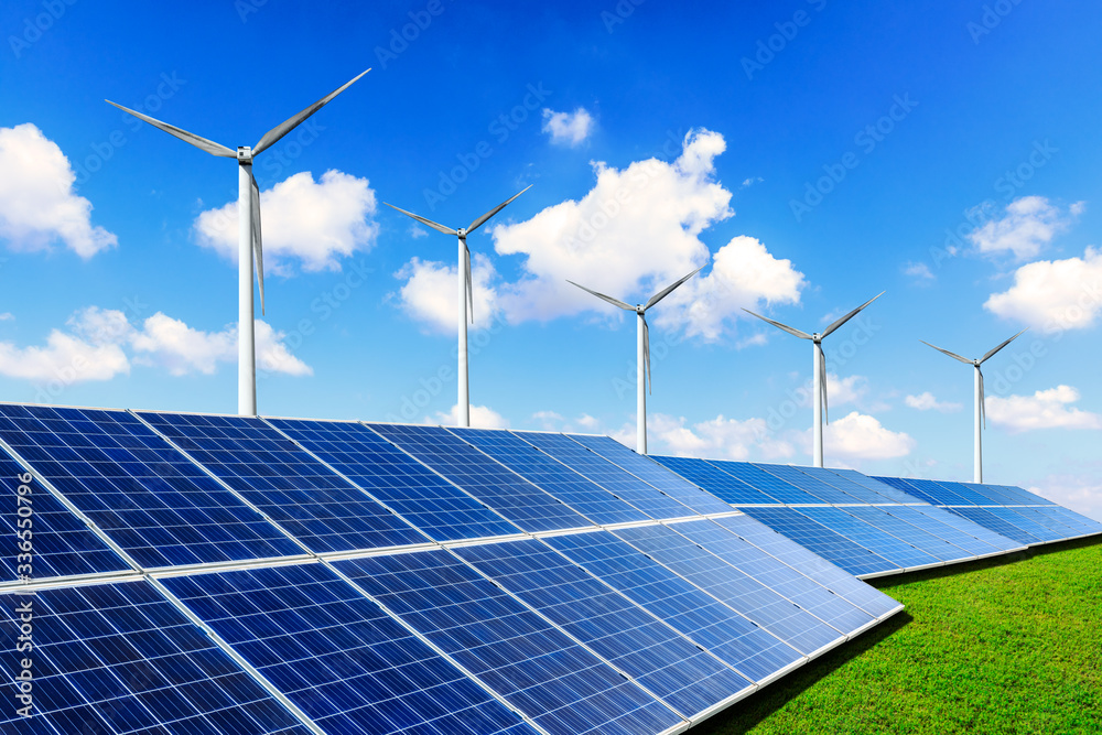 Solar panels with wind turbines on a sunny day,green clean energy concept.