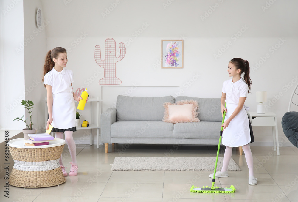 Cute little chambermaids cleaning room