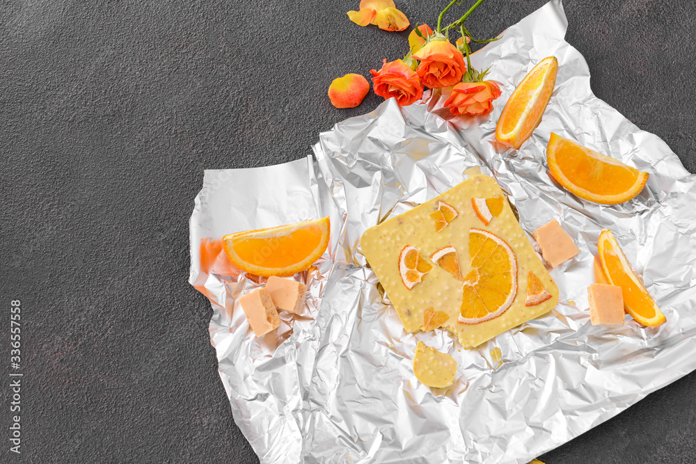 Sweet white chocolate with orange on table