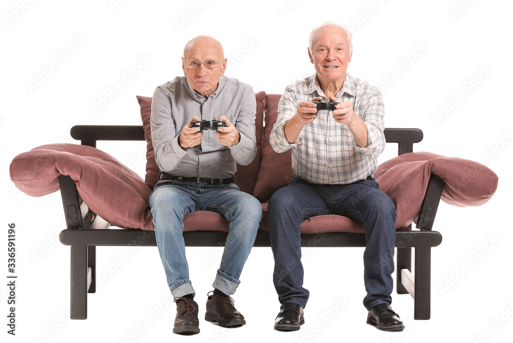 Portrait of elderly men playing video games on white background