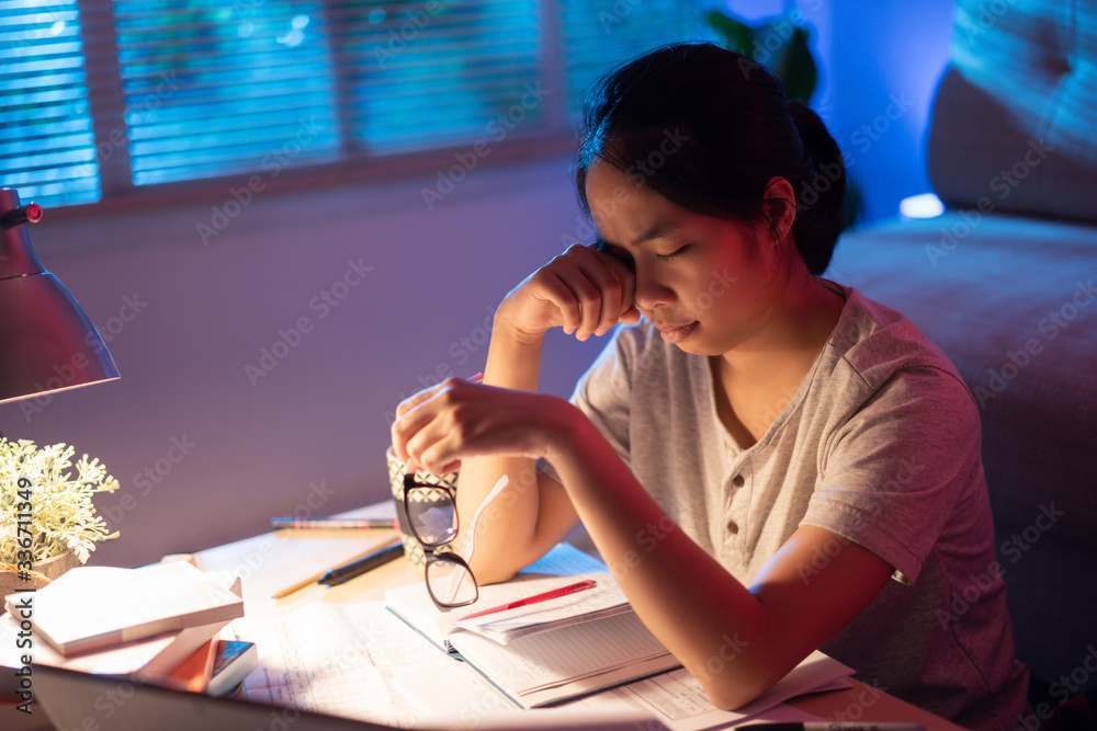 Asian women tired from working at home She felt sleepy yawning.