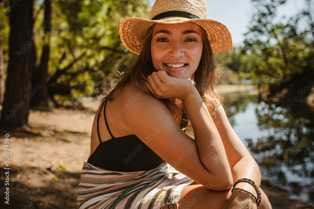 Beautiful woman sitting by the lake