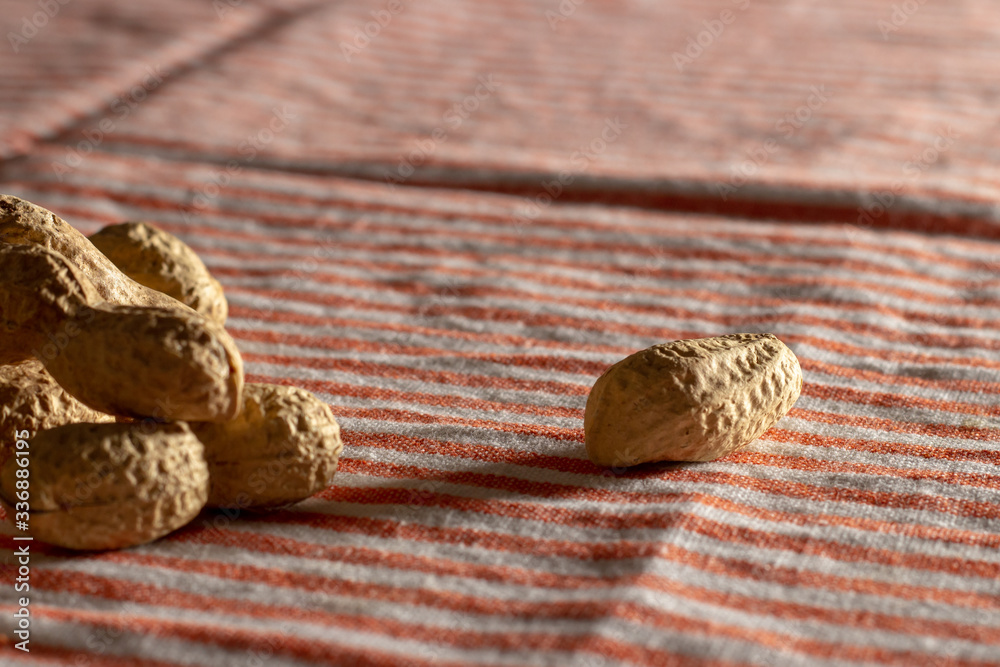 peanuts on a tea towel under rays of the sun