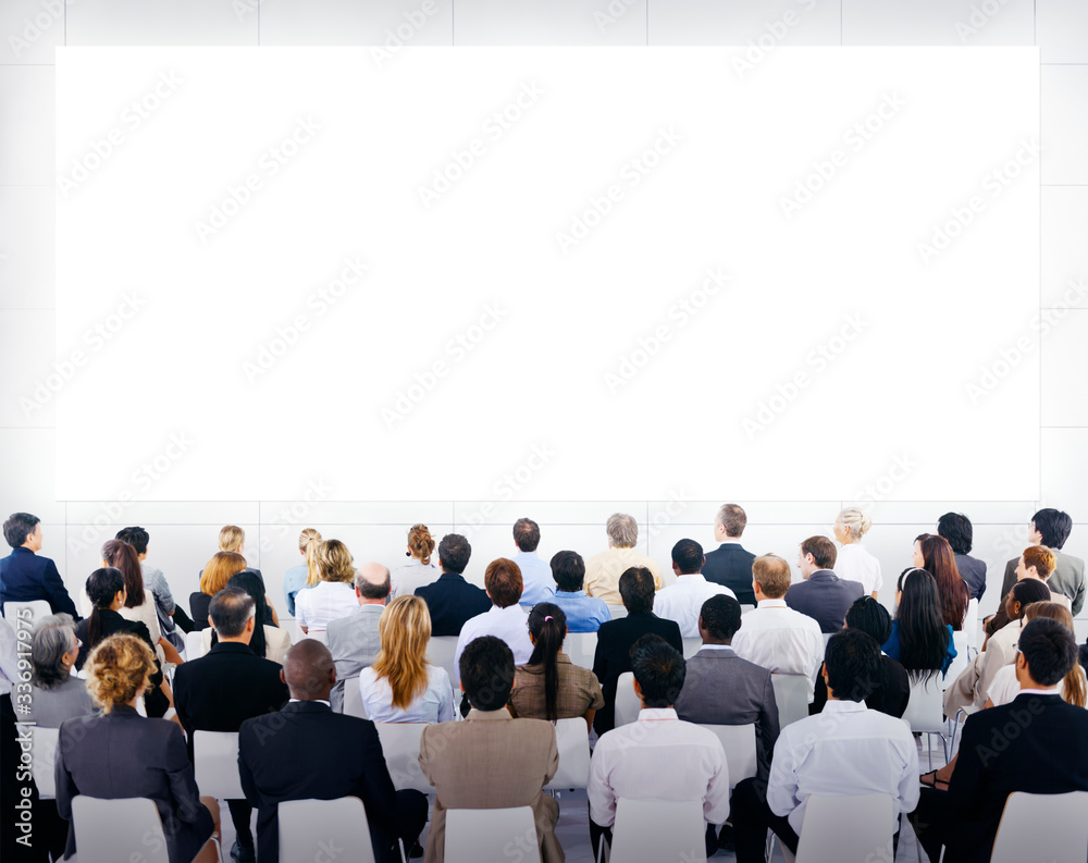 Group of business people sitting and looking at the blank presenation.