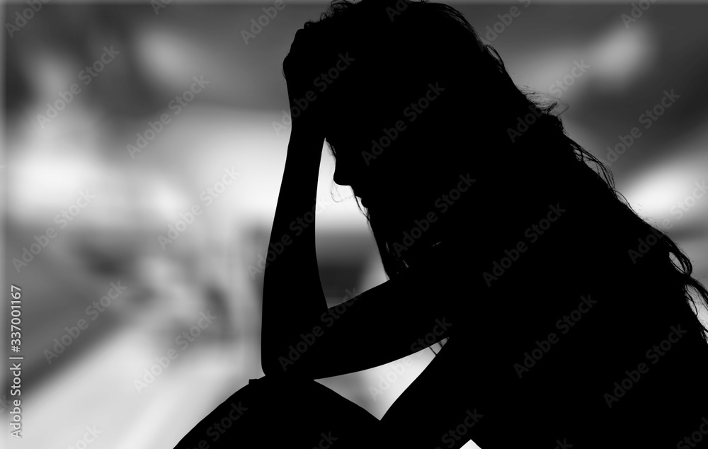 Silhouette of dark womans head on gray background