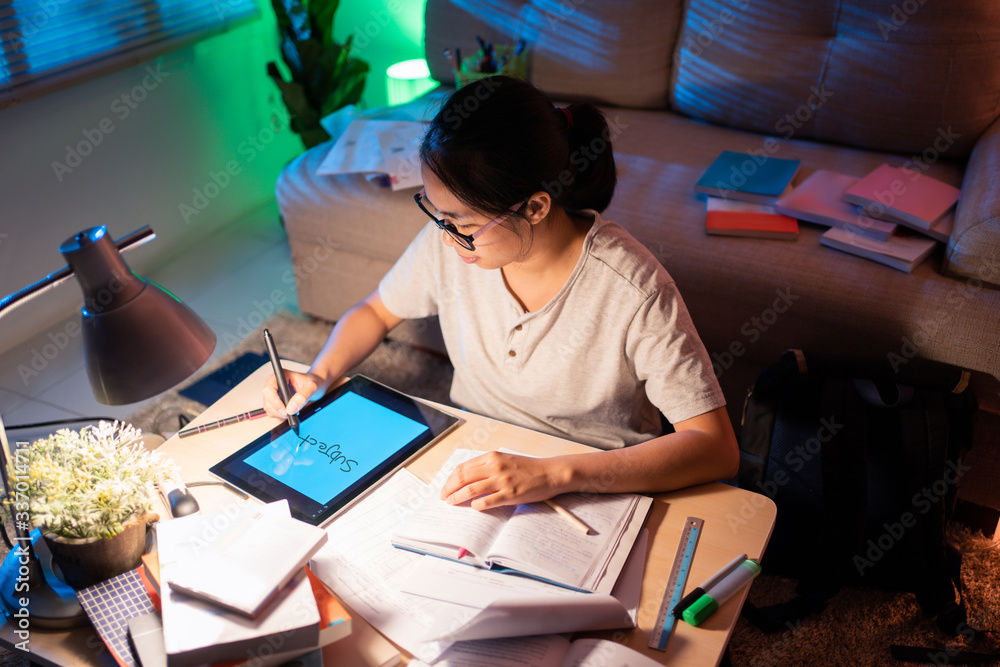  Woman sitting on a desk She is at home at night