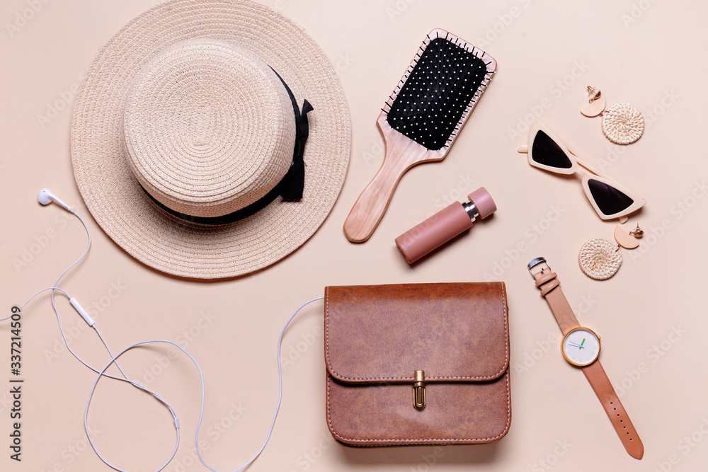 Stylish bag with female accessories on light background