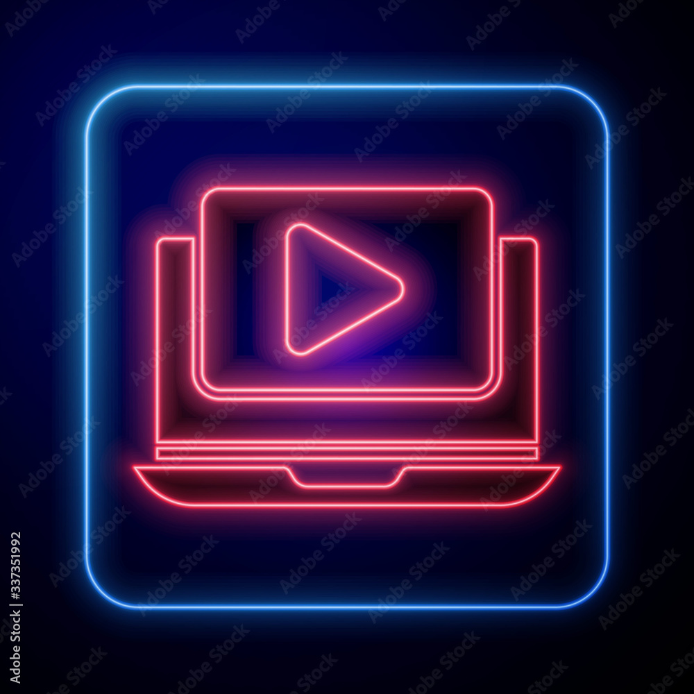 Glowing neon Online play video icon isolated on blue background. Laptop and film strip with play sig