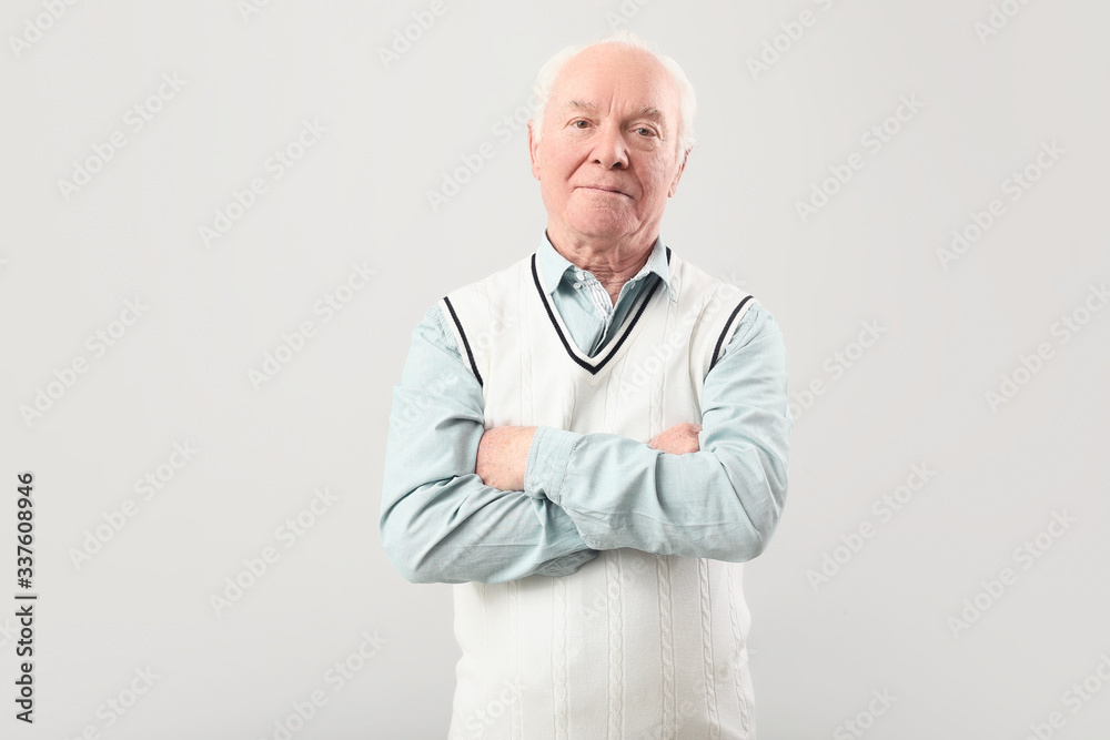 Portrait of elderly man on grey background