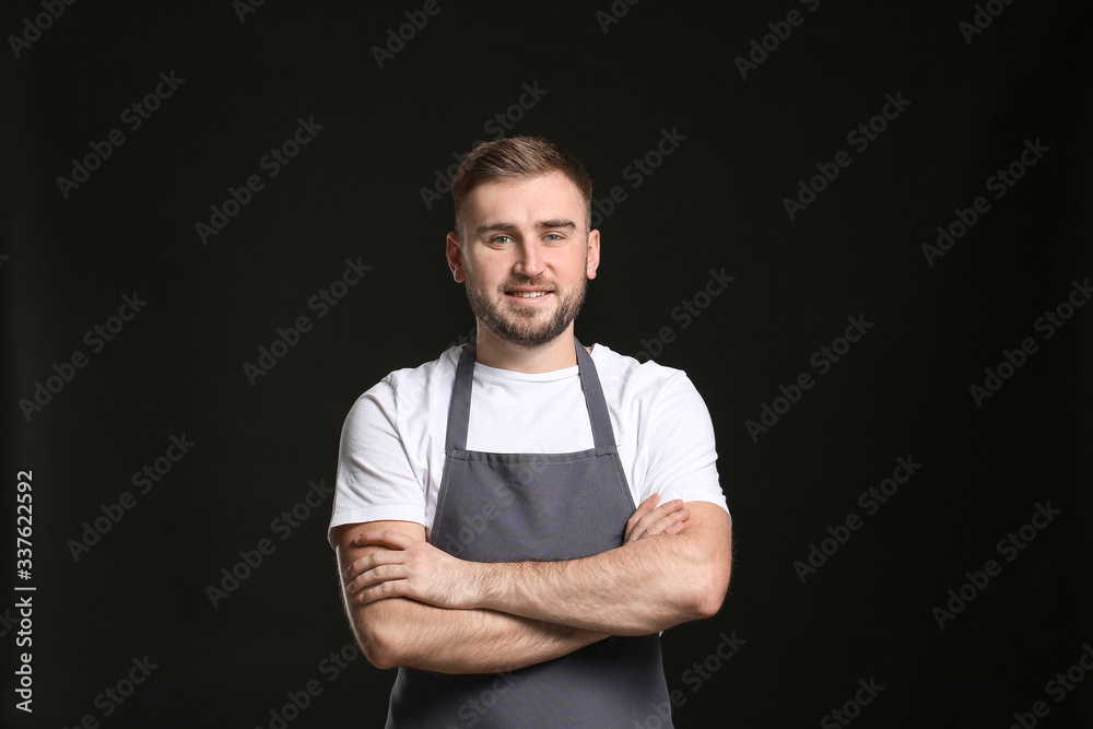 Handsome male chef on dark background