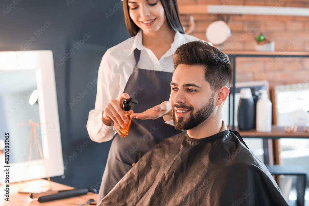 Hairdresser working with client in salon