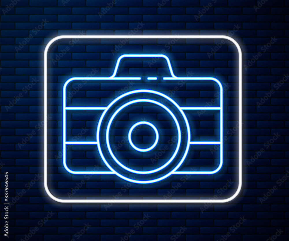 Glowing neon line Photo camera icon isolated on brick wall background. Foto camera icon. Vector Illu