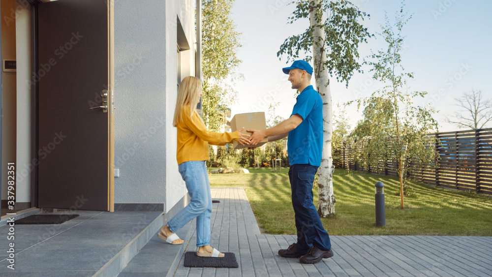 Delivery Man Delivers Cardboard Box Package to a Beautiful Young Woman, Who will Sign Electronic Sig