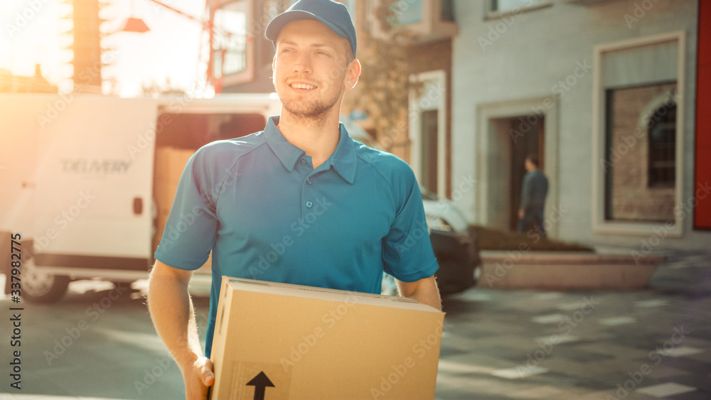 Portrait of Delivery Man Holds Cardboard Box Package Standing in Modern Stylish Business District wi