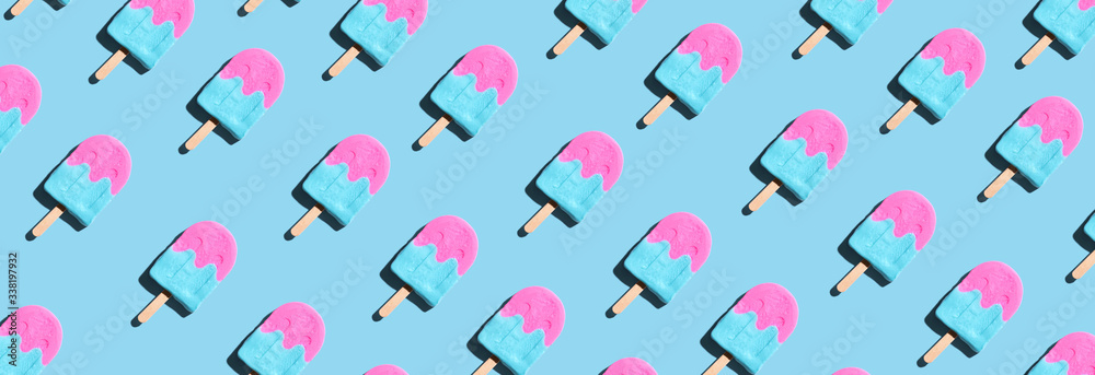 Pink and blue popsicles with shadow - overhead view