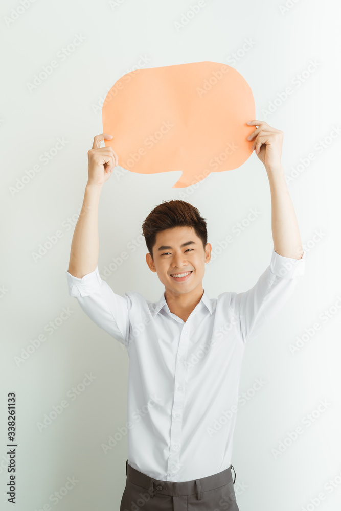 Handsome asian man holding a cardboard speech bubble paper