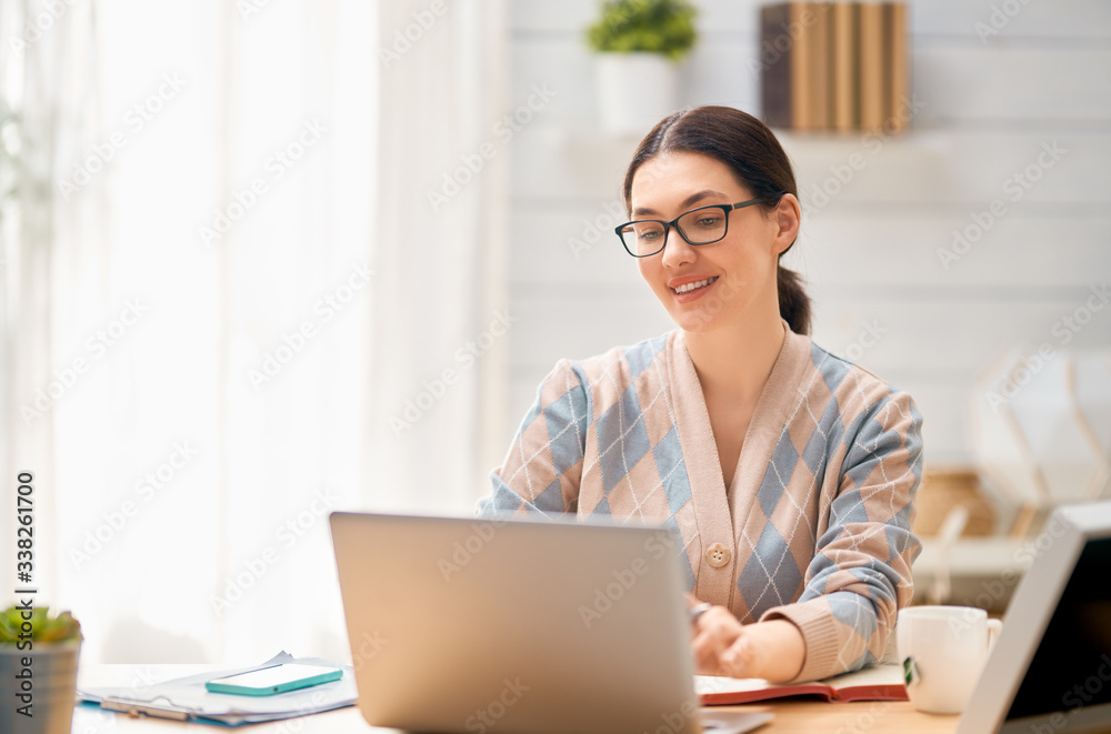 Woman working on a laptop.