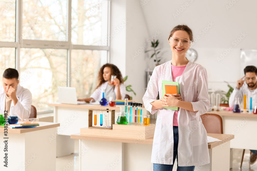 Young woman at chemistry lesson in classroom