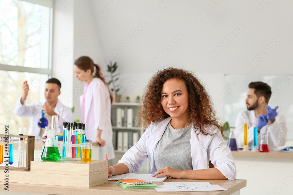 Young woman at chemistry lesson in classroom