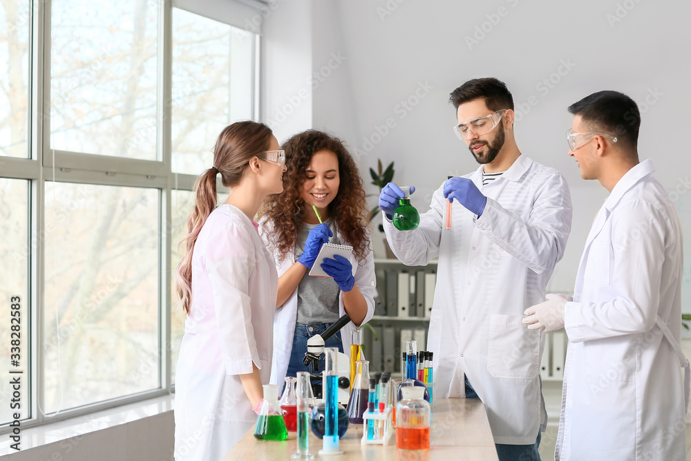 Young people at chemistry lesson in classroom