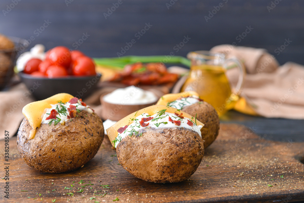 Tasty baked potato with sour cream on table