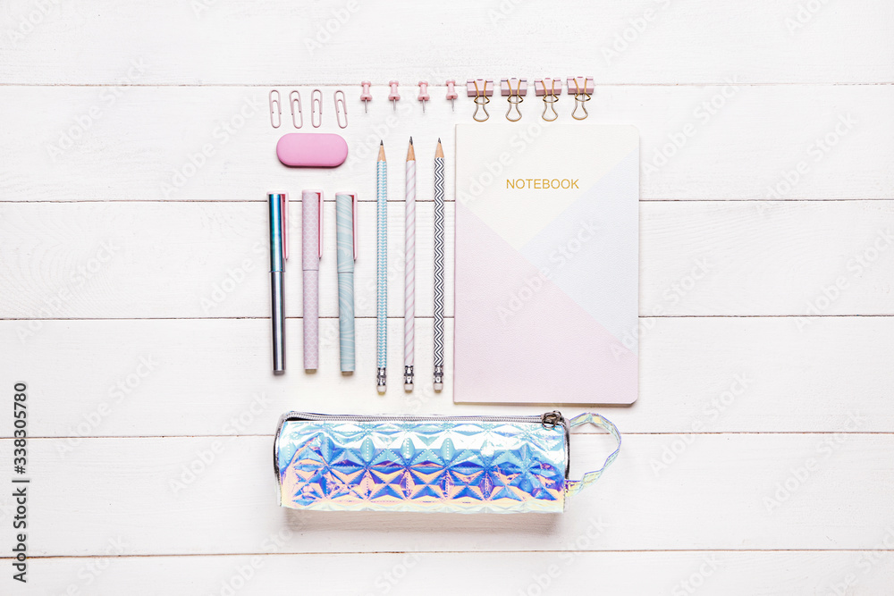 Pencil bag with stationery on wooden background