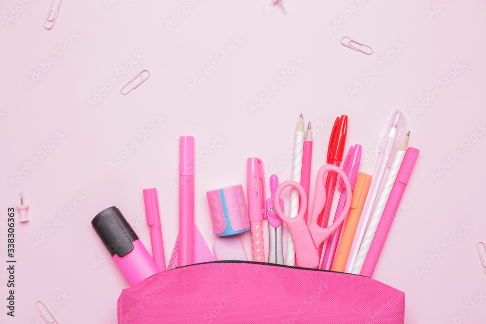 Pencil bag with stationery on color background