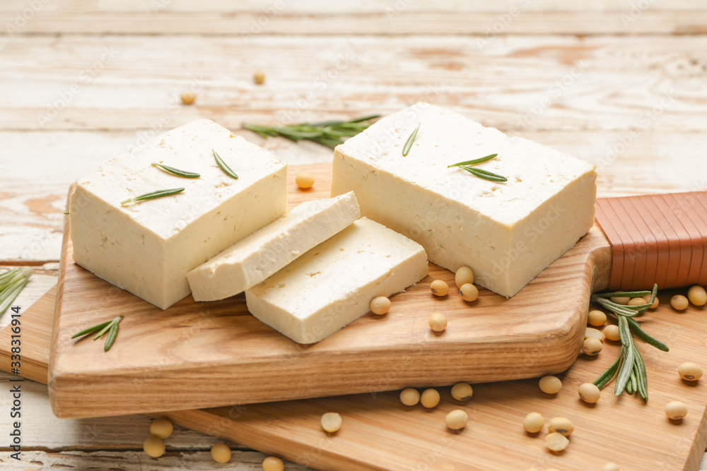 Boards with tasty tofu cheese on table