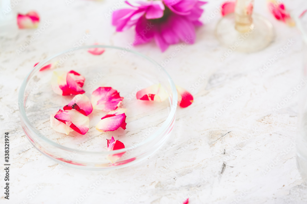 Petri dish with perfume sample on table