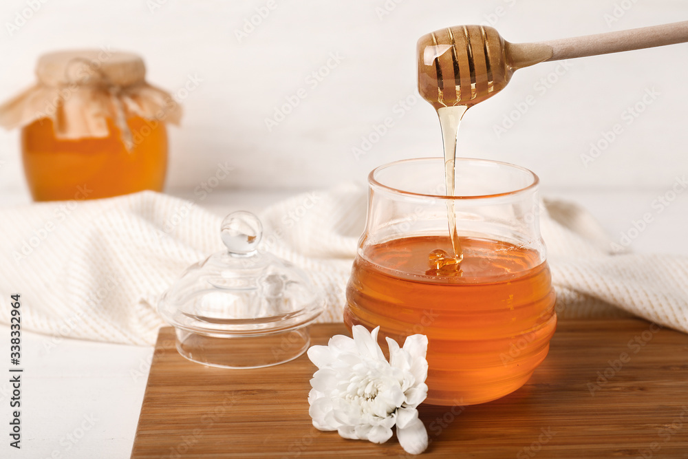 Jar of sweet honey on table