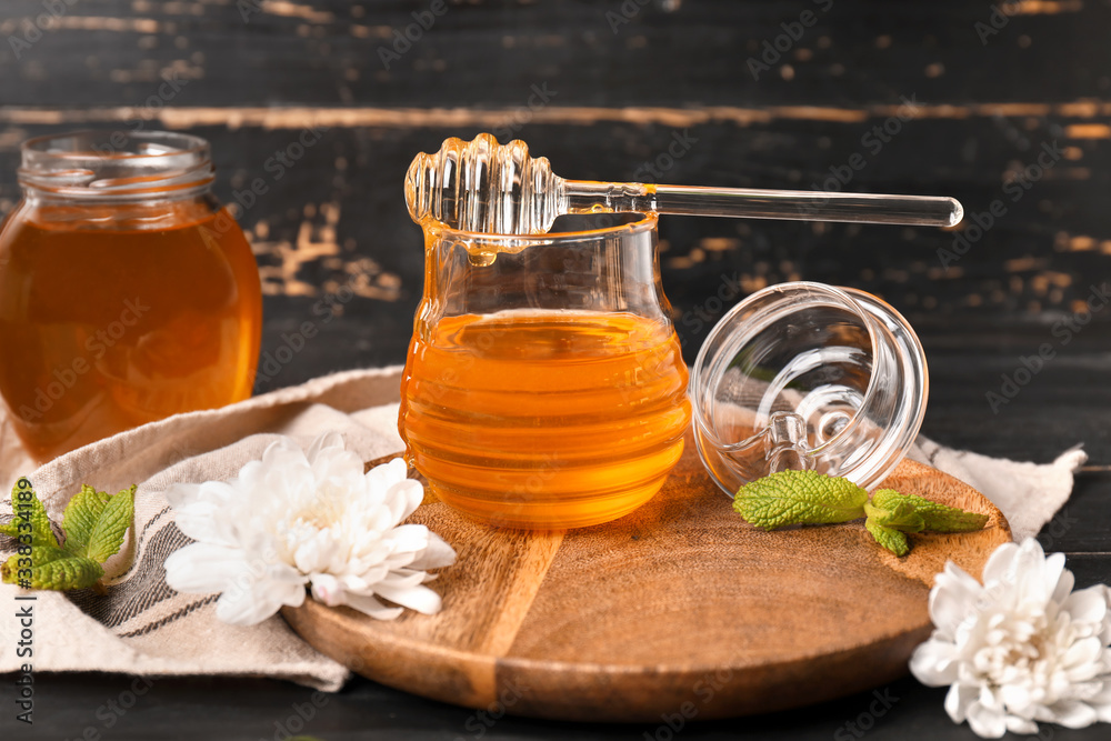 Jar of sweet honey on table