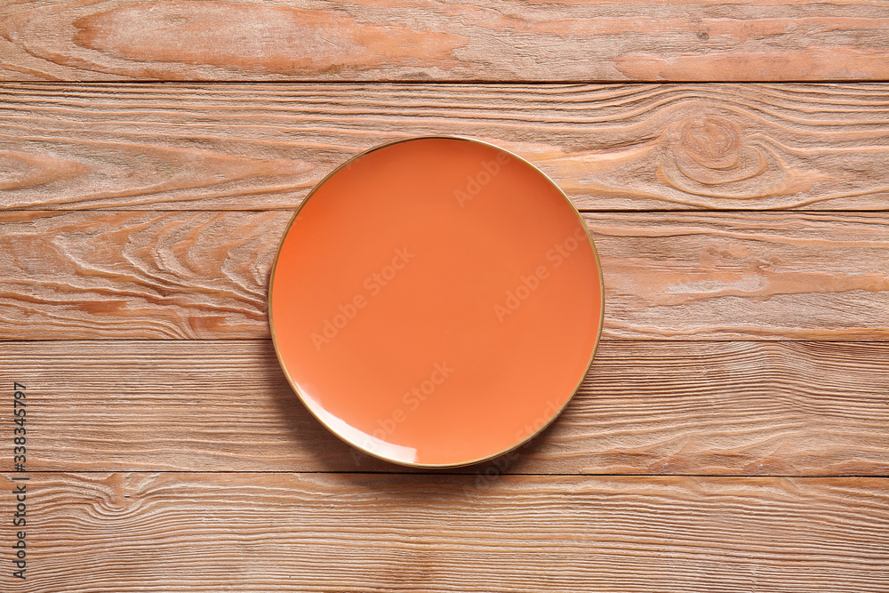 Clean plate on wooden background