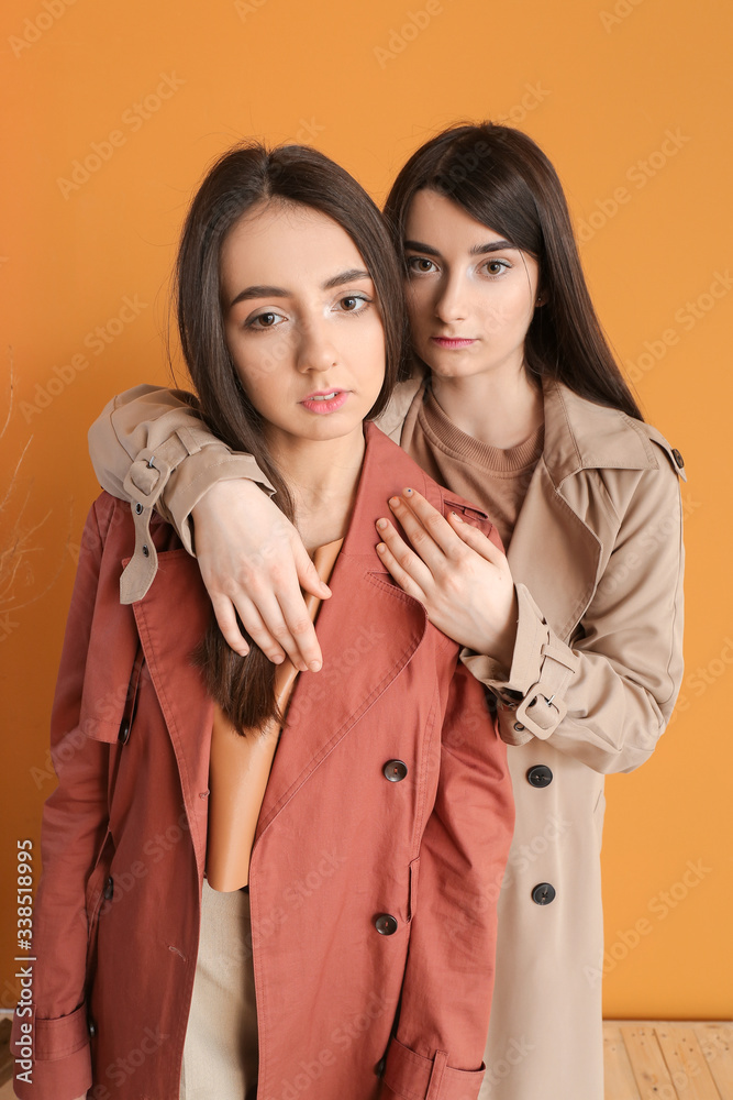 Stylish young women on color background