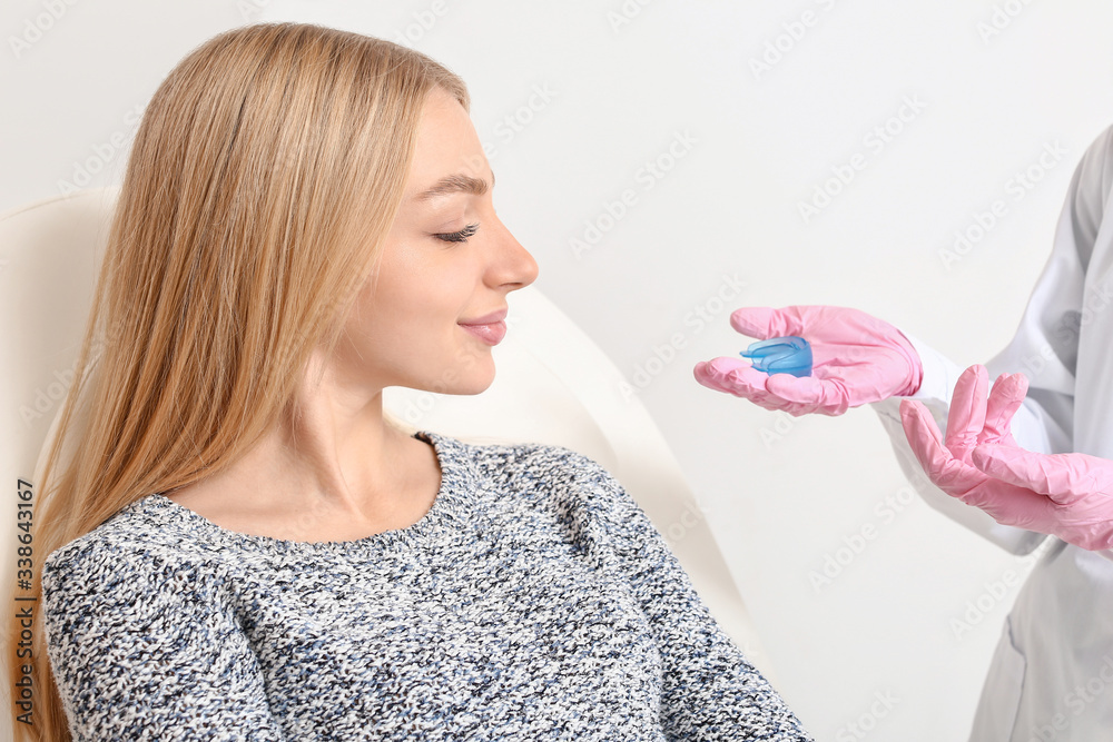 Young woman visiting orthodontist in clinic