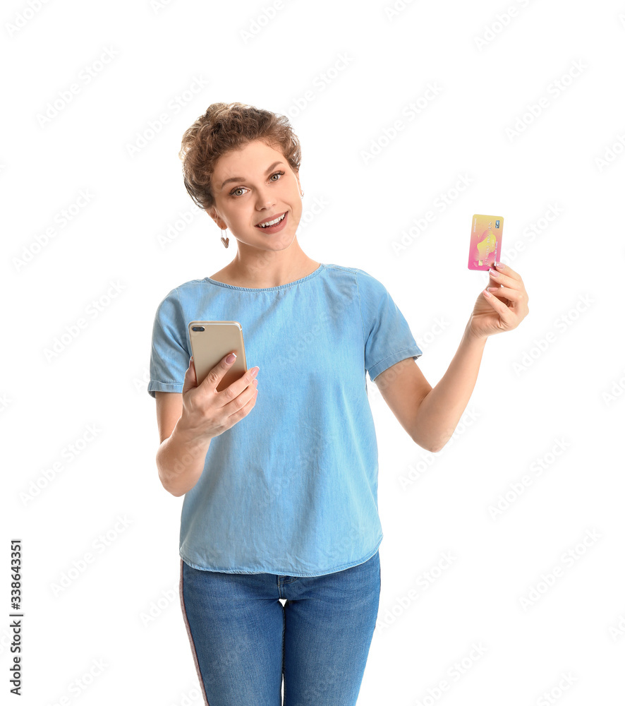 Beautiful young woman with mobile phone and credit card on white background. Online shopping concept