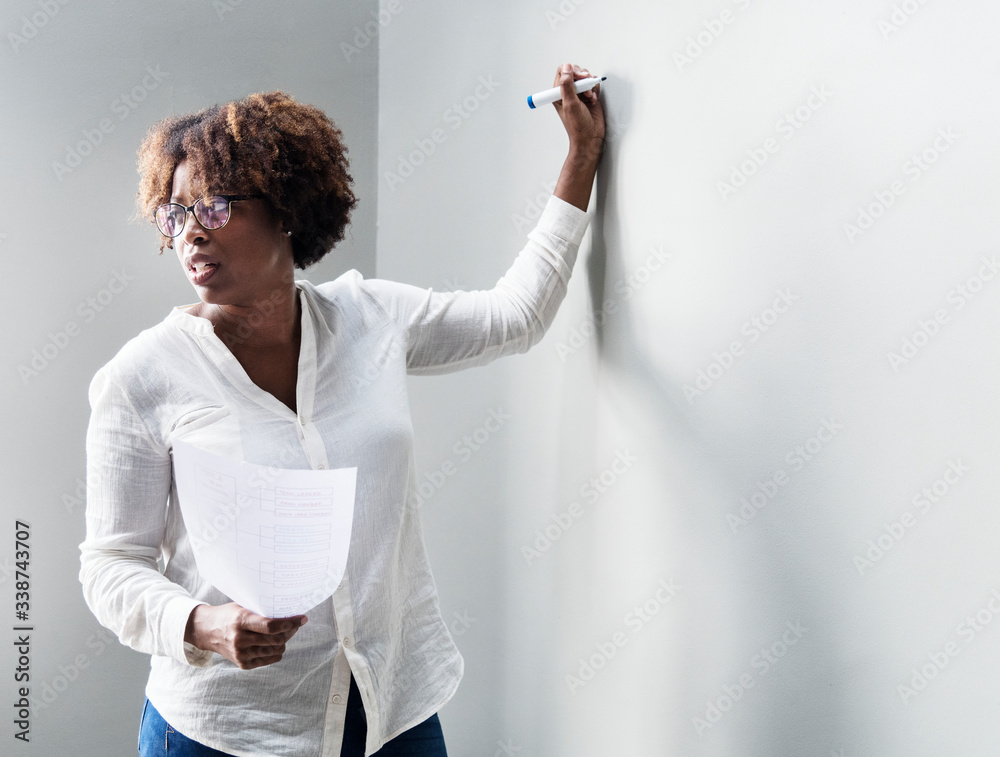 Woman writing on a white wall