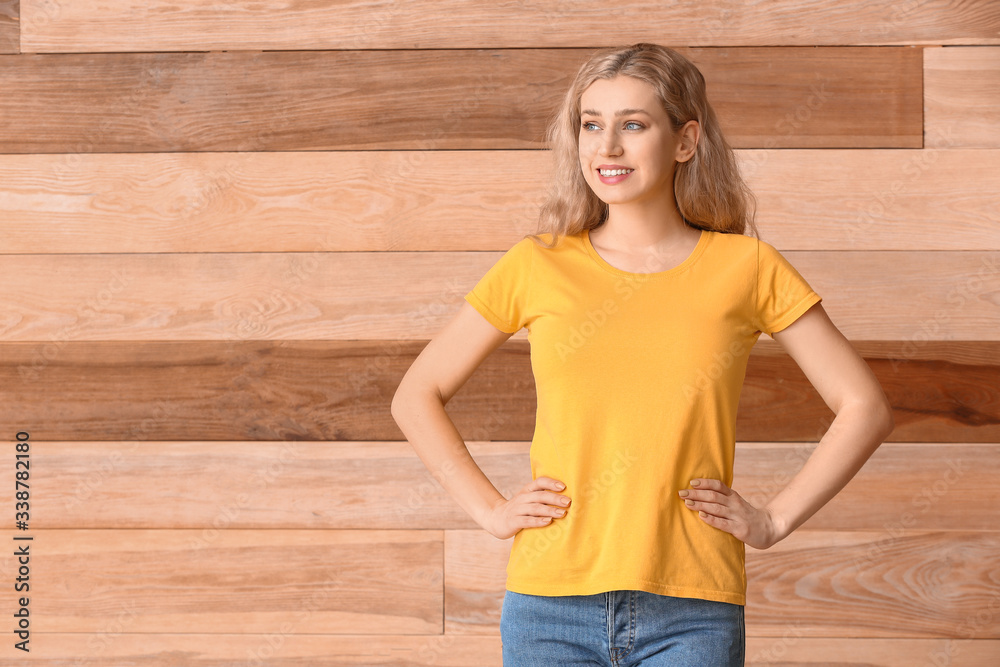 Woman in stylish t-shirt on wooden background