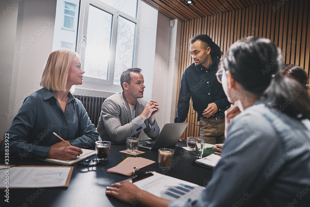 Mature businessman talking with colleagues during a boardroom me