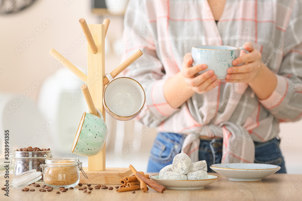 Woman drinking hot coffee in kitchen