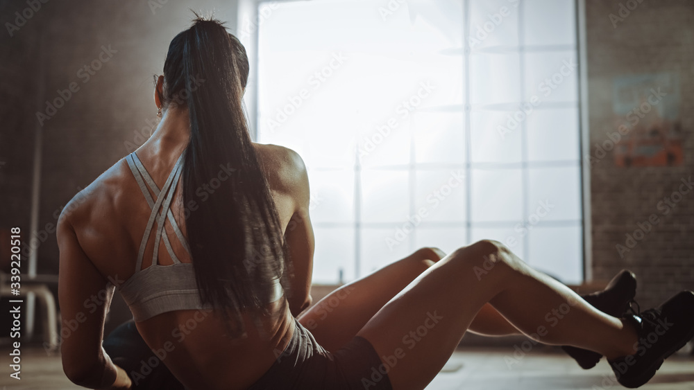 Close Up of a Strong and Fit Athletic Woman in Sport Top Doing Core and Ab Exercises with Ball in a 