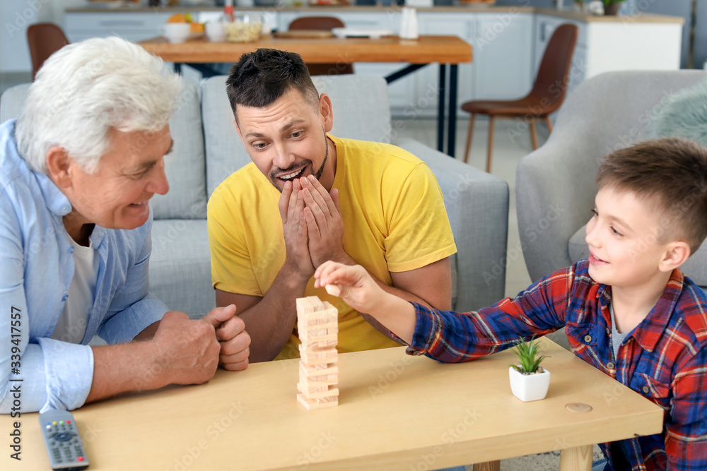 Man with his father and son spending time together at home