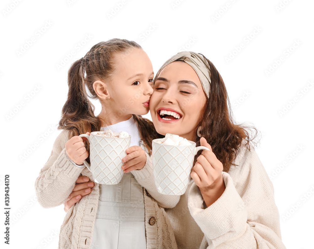 Woman and her little daughter with tasty cocoa drink on white background