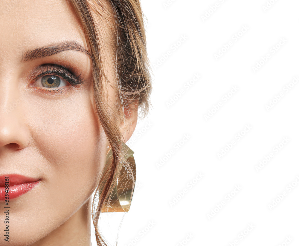 Young woman with beautiful jewellery on white background, closeup