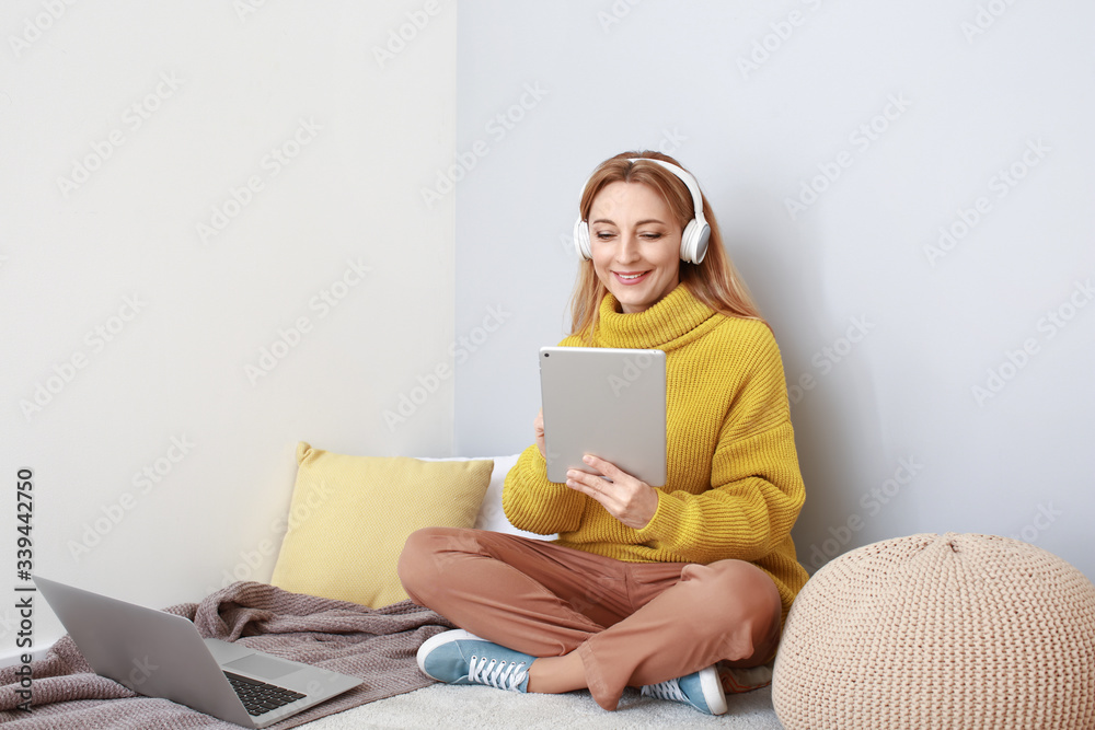 Mature woman using tablet computer for online learning at home