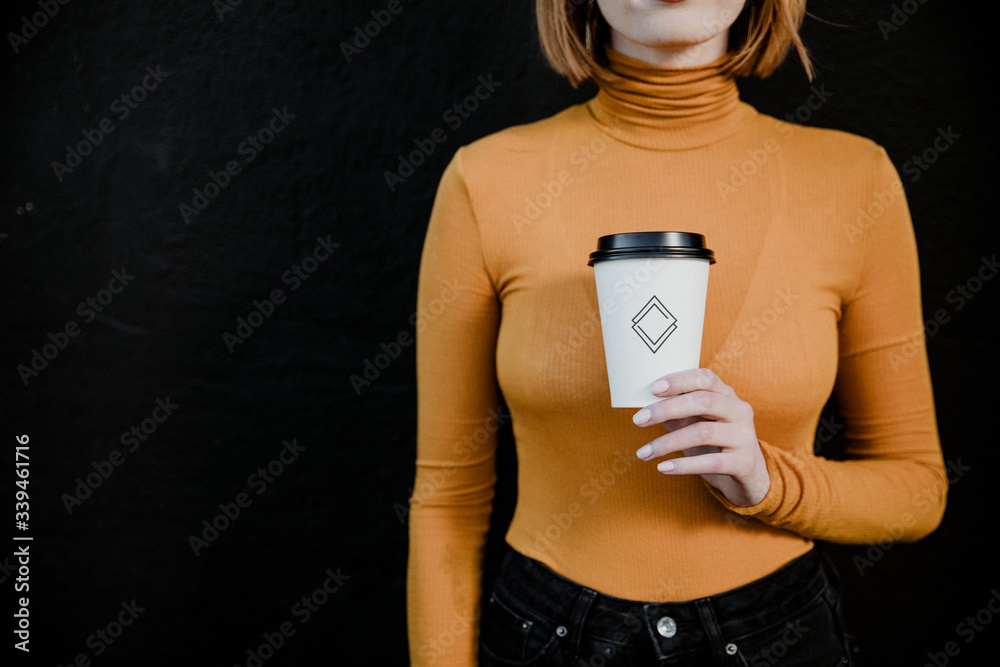 Woman holding a takeaway coffee cup