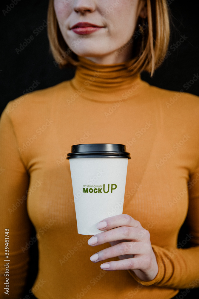 Woman holding a takeaway coffee cup