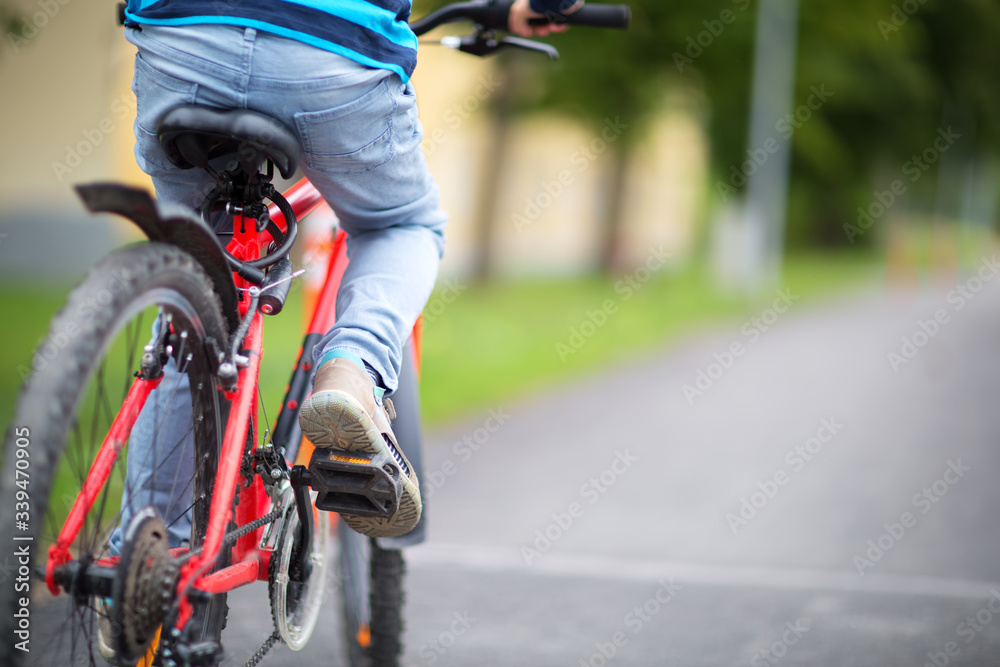 child on a bicycle at asphalt road in early morning