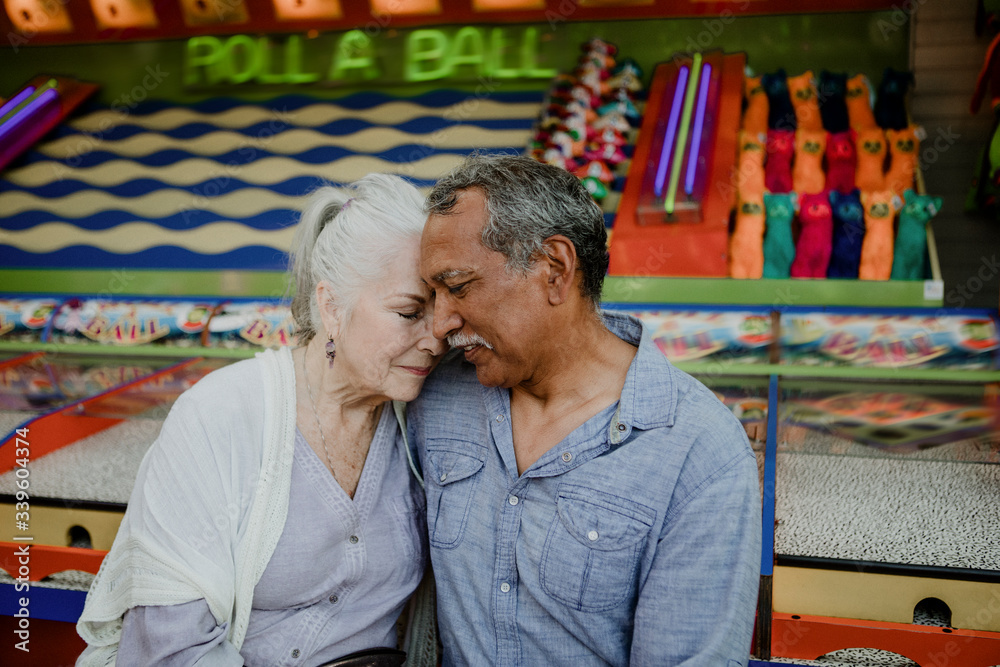 Senior couple resting by a game booth